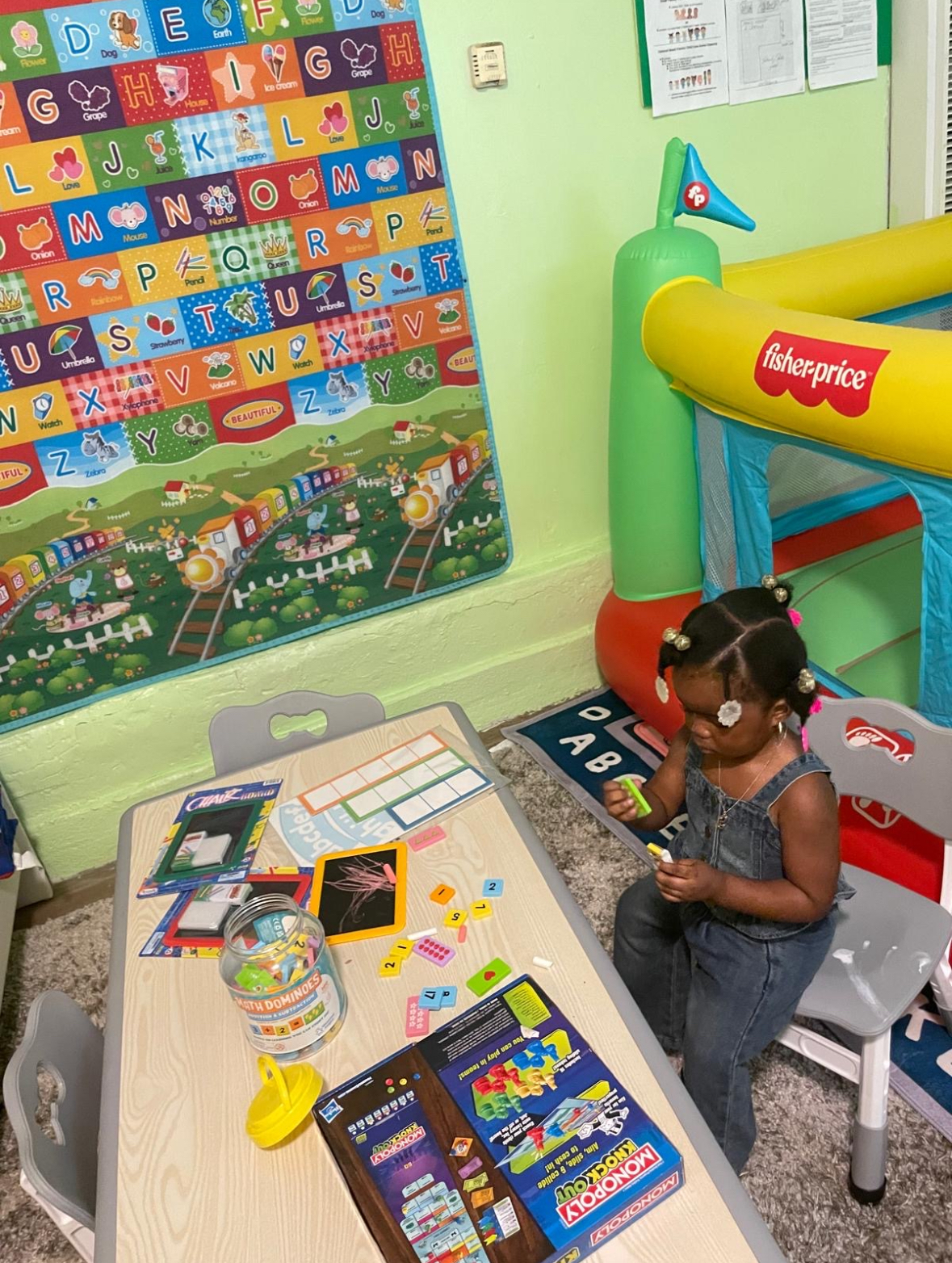 Child doing hands-on learning activities at Zion Family Home Day Care